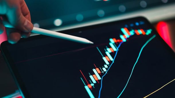 Close-up of cryptocurrency trading analysis on a digital tablet, highlighting market trends.